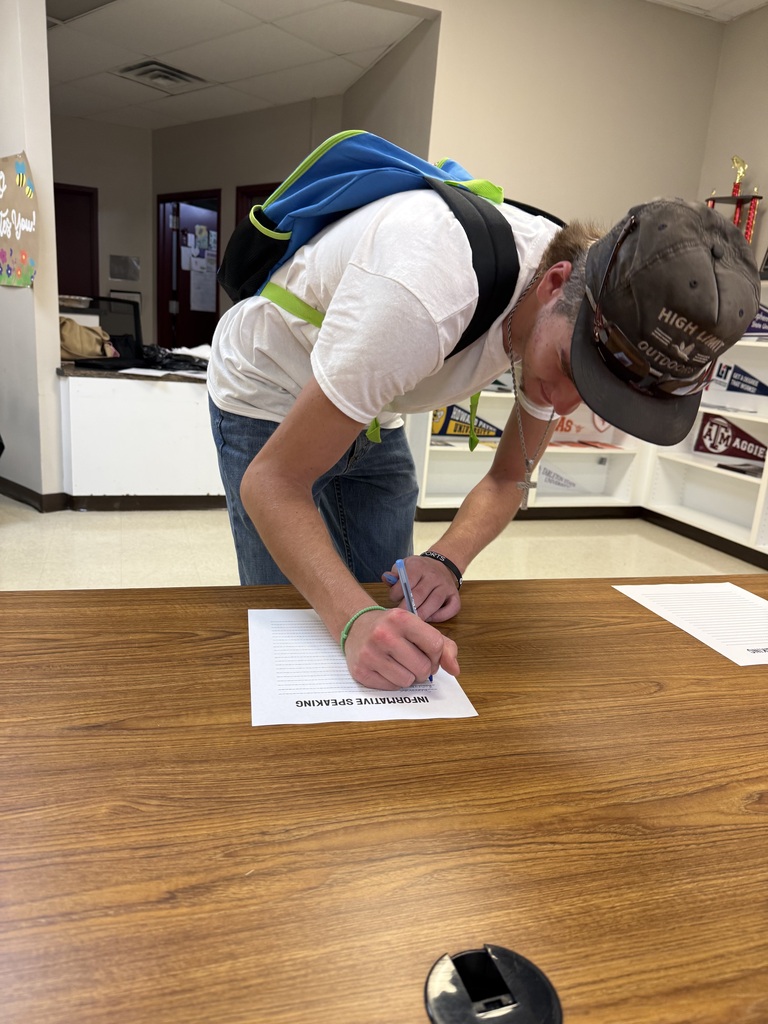 student signing a paper