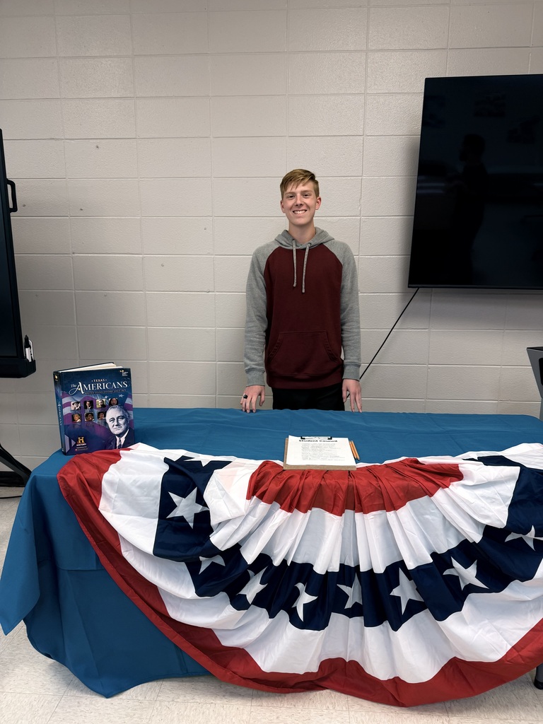 student in front of patriotic table