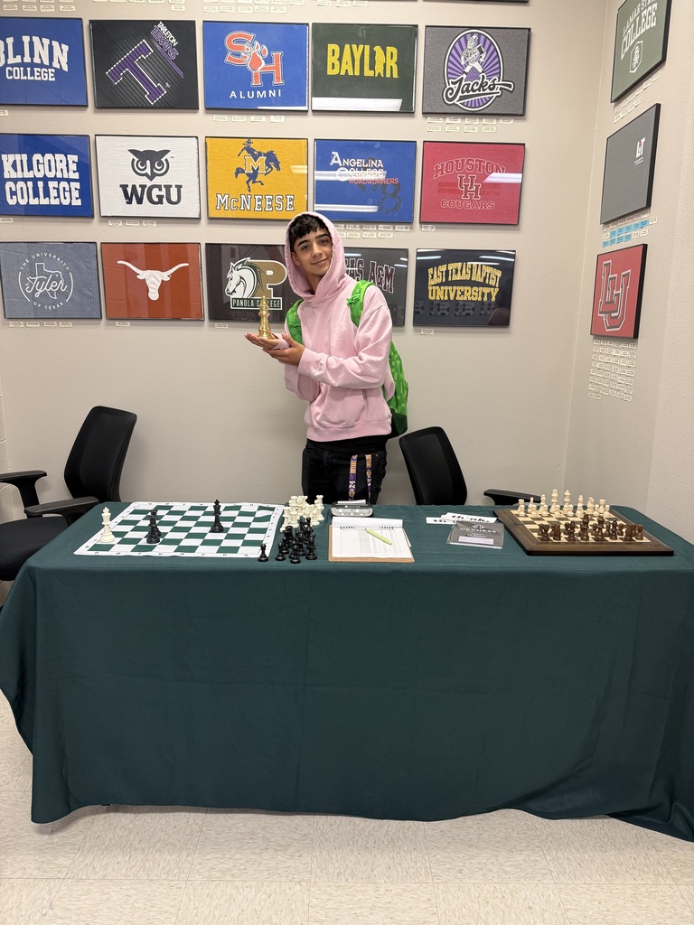 student in front of chess baords