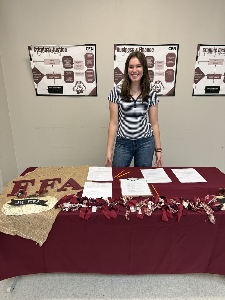 student in front of ffa table