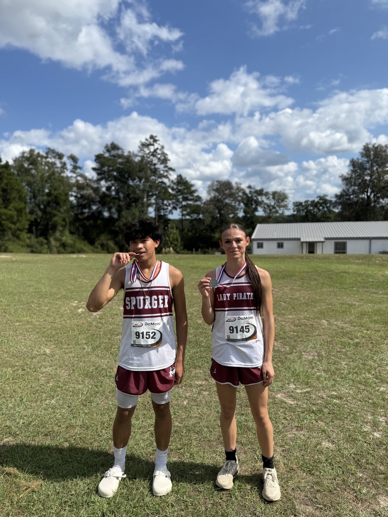 cross country, girl and boy with medals