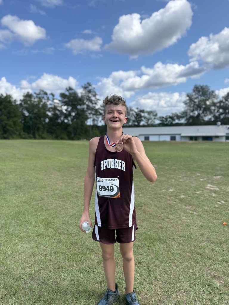 cross country boy with medal