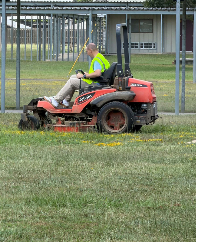 superintendent cuts the lawn