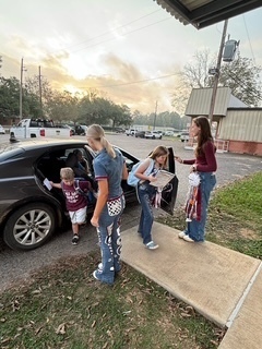 helping student out of the car