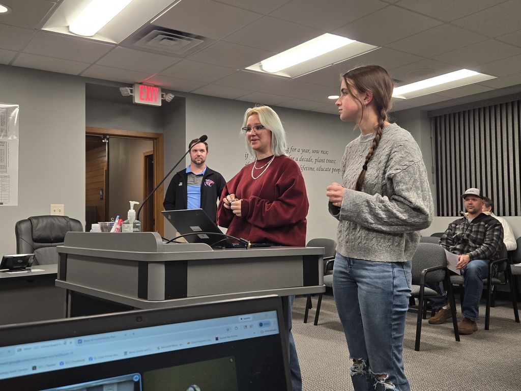High School Marching Band Director Sean Conway with students Zynx and Lilly discuss the fall marching band season