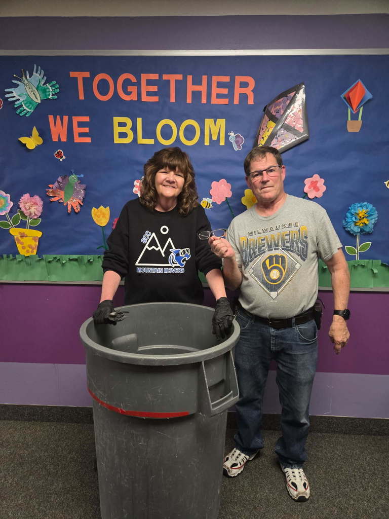 SCC staff holding the missing pair of glasses