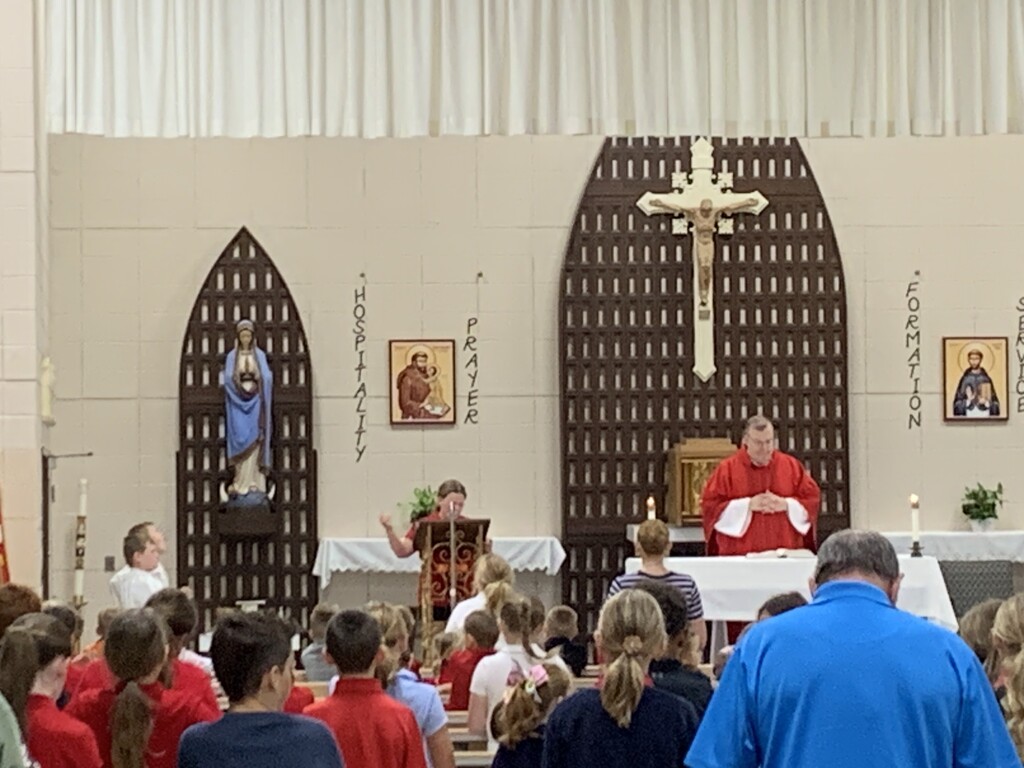 Fifth grade leaders at School Mass on Wednesday, September 16, 2026, reading the Scripture.