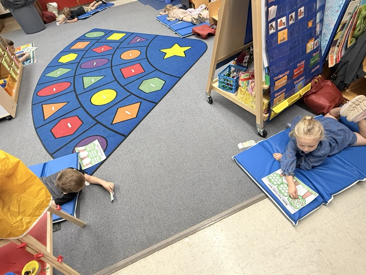 we worked on crossing the midline by laying on our mats and getting an apple sticker on one side of our mat and then putting it on our tree paper on the other side of our mat without switching our hand in the middle! That was tough work!