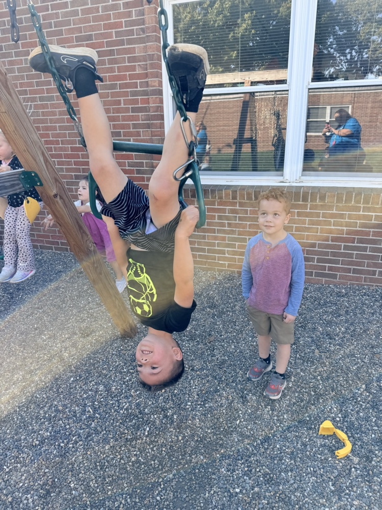 hanging upside down from the trapeze bar!