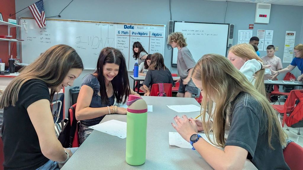 Middle school students work on critical thinking skills in math with a dice game. 