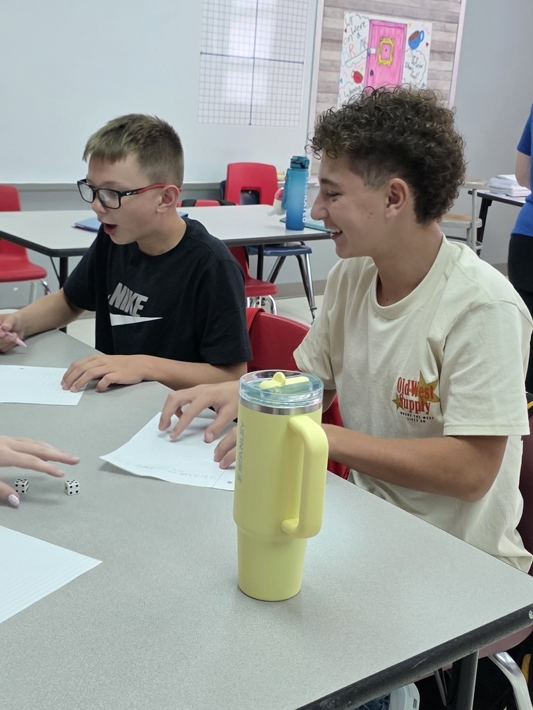 Middle school students work on critical thinking skills in math with a dice game. 