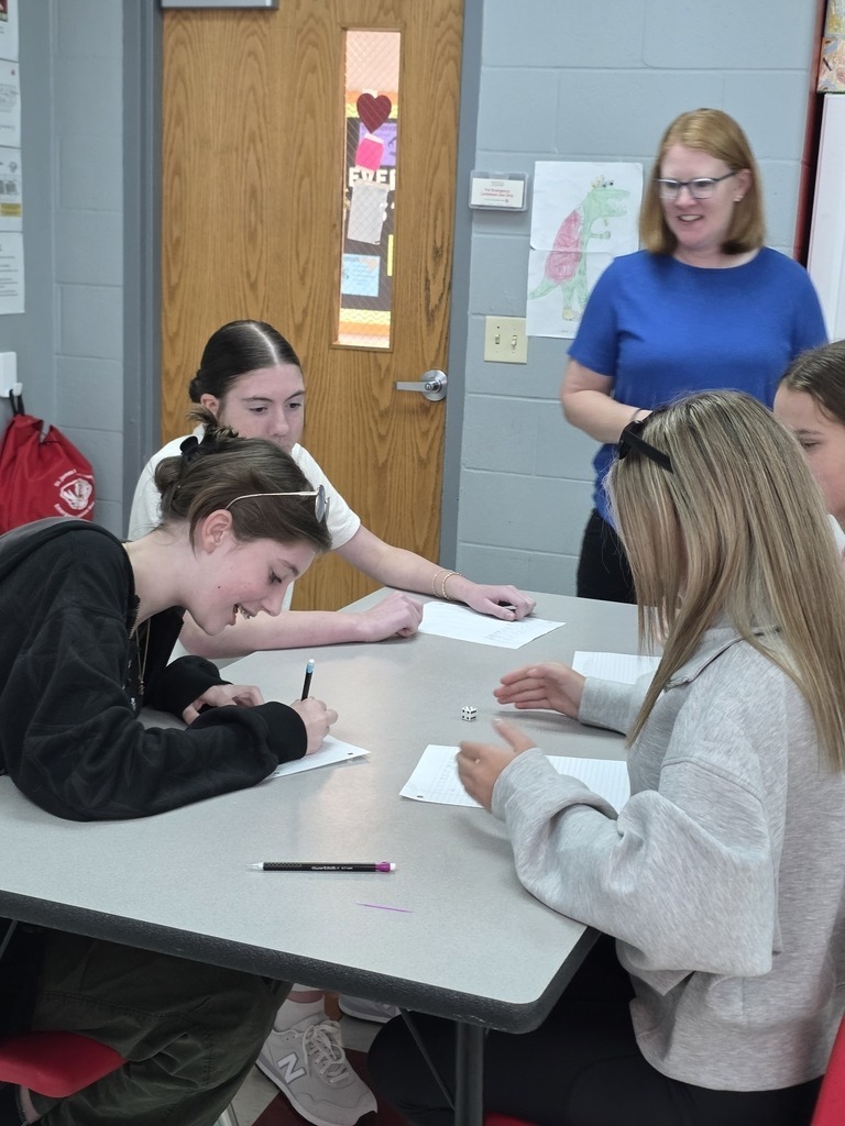 Middle school students work on critical thinking skills in math with a dice game. 