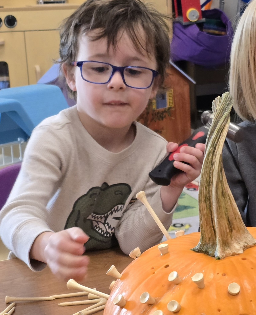 Tiger Cubs student hammer pumpkins to work on hand-eye coordination. 