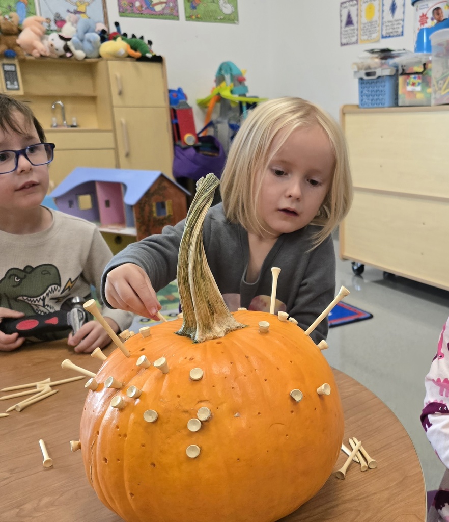 Tiger Cubs student hammer pumpkins to work on hand-eye coordination. 