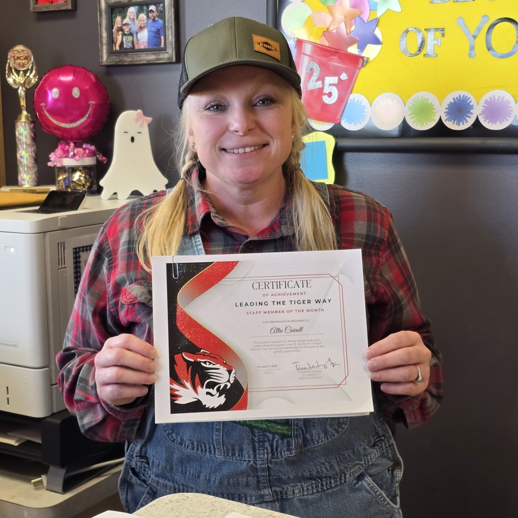 October Leading the Tiger Way winner is presented with their certificate. 