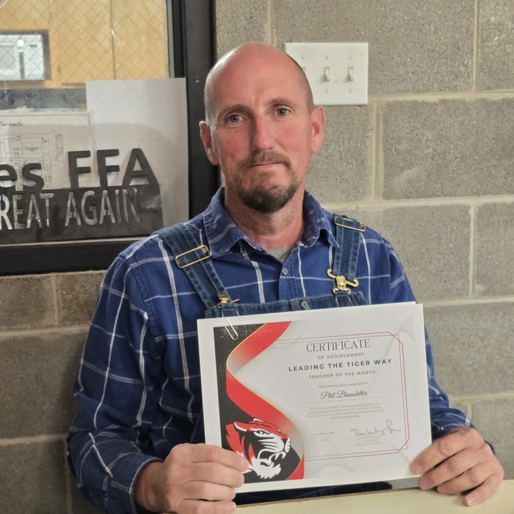 October Leading the Tiger Way winner is presented with their certificate. 