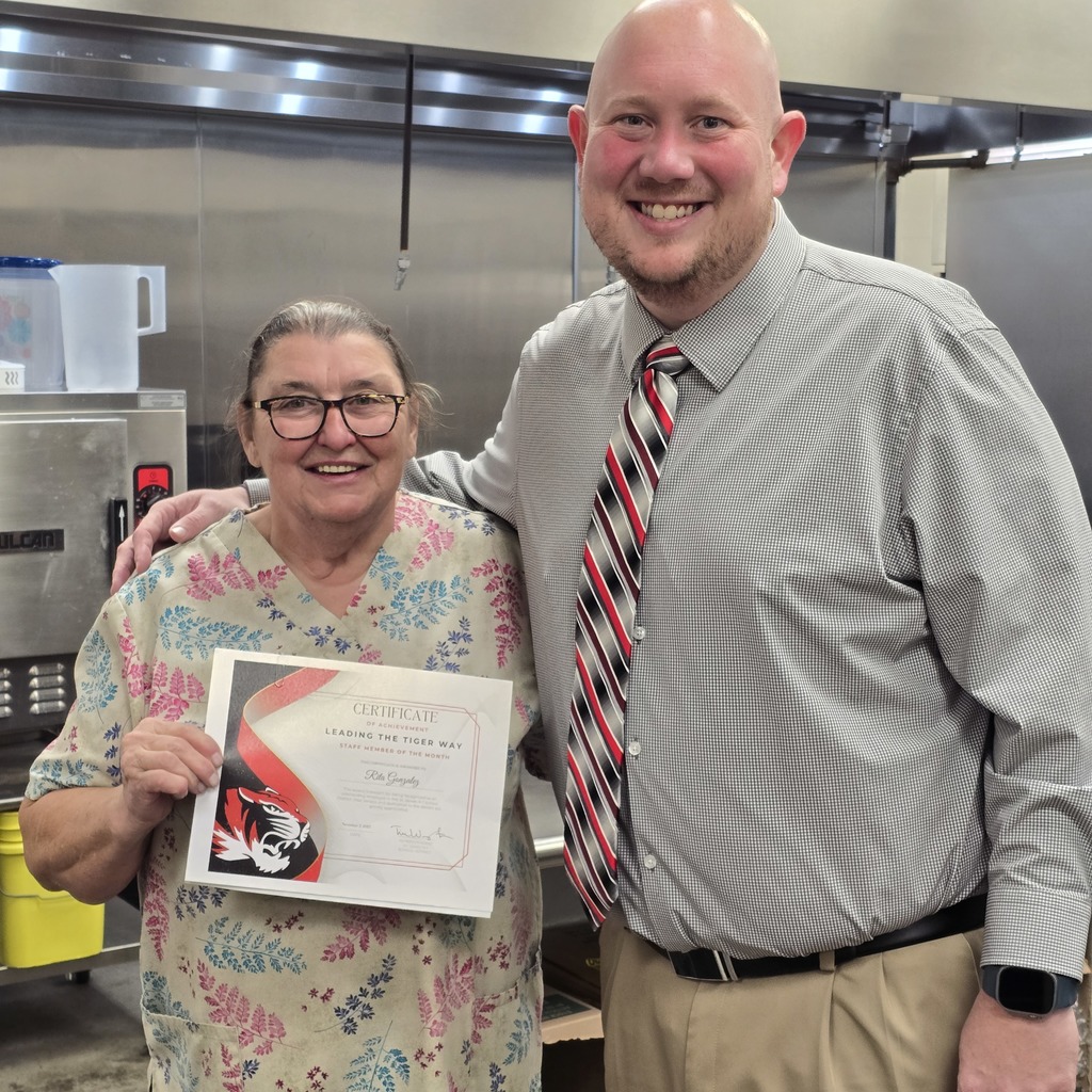 October Leading the Tiger Way winner is presented with their certificate. 