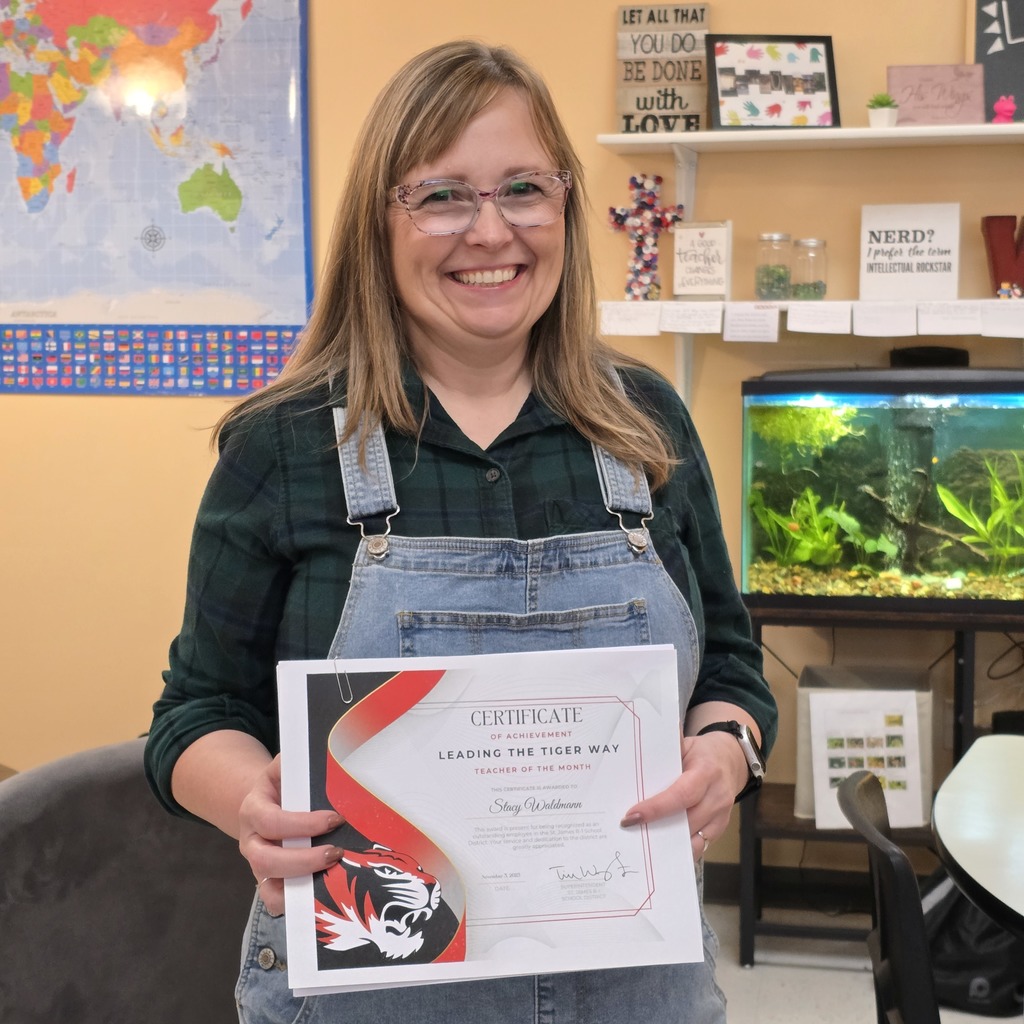 October Leading the Tiger Way winner is presented with their certificate. 