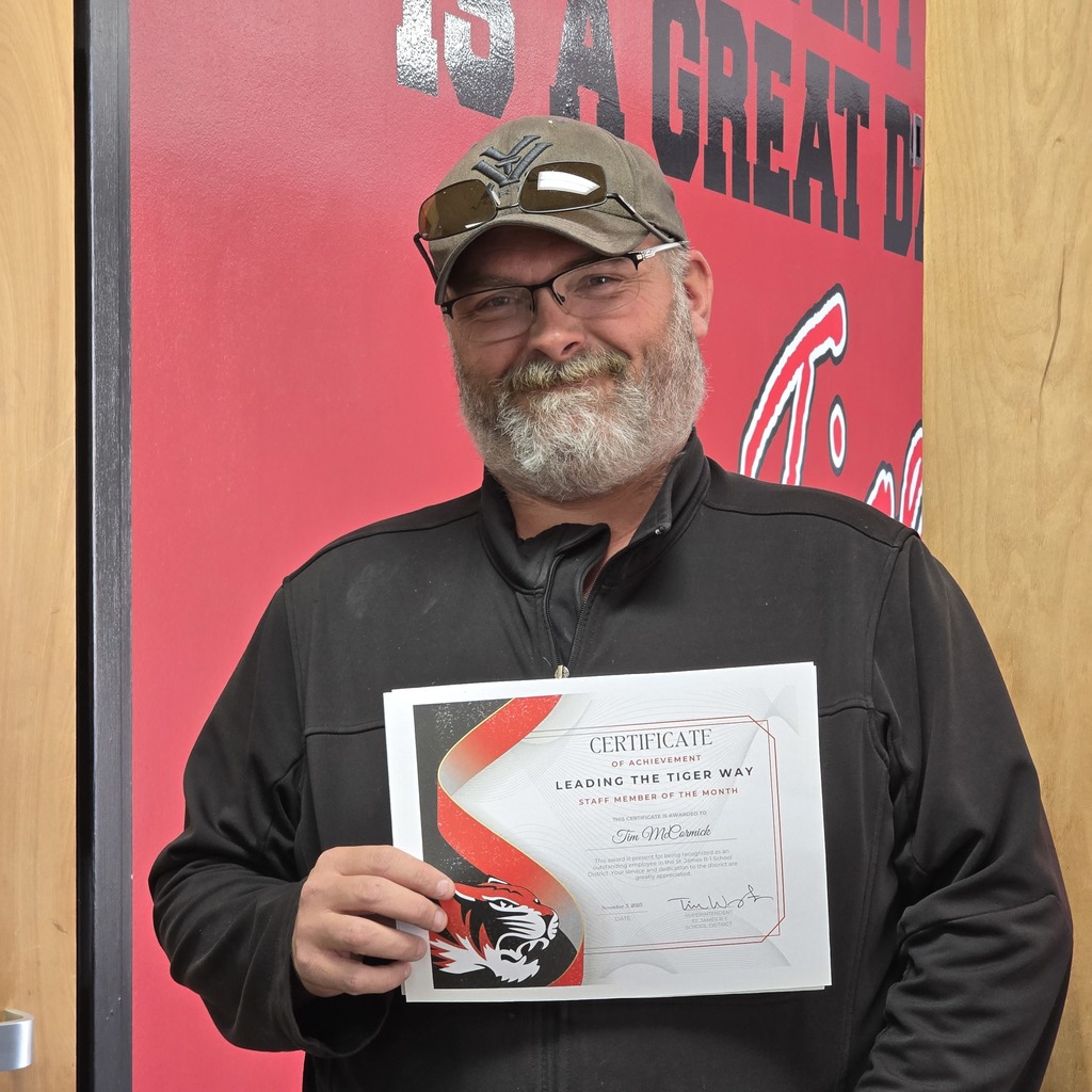 October Leading the Tiger Way winner is presented with their certificate. 