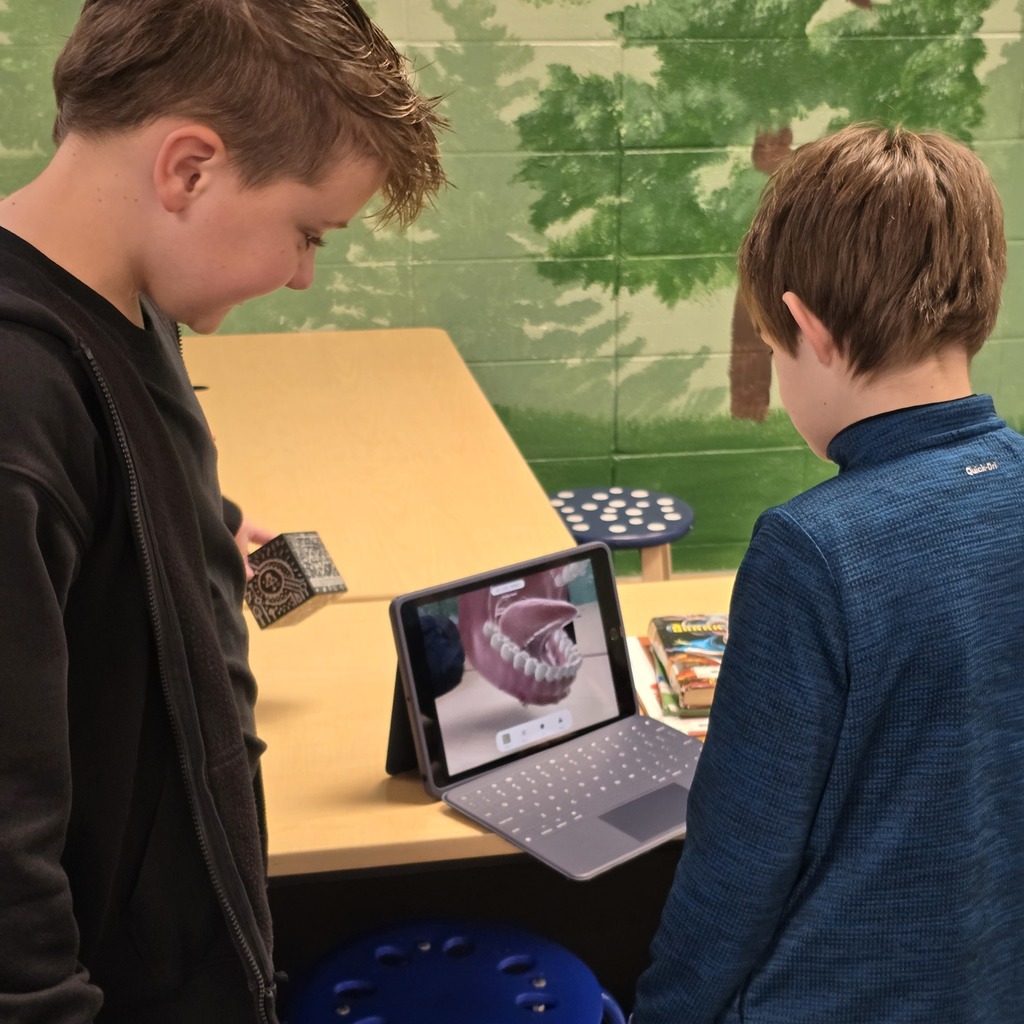 3rd grade students use Merge Cubes in the library to explore the human body for their science unit. 