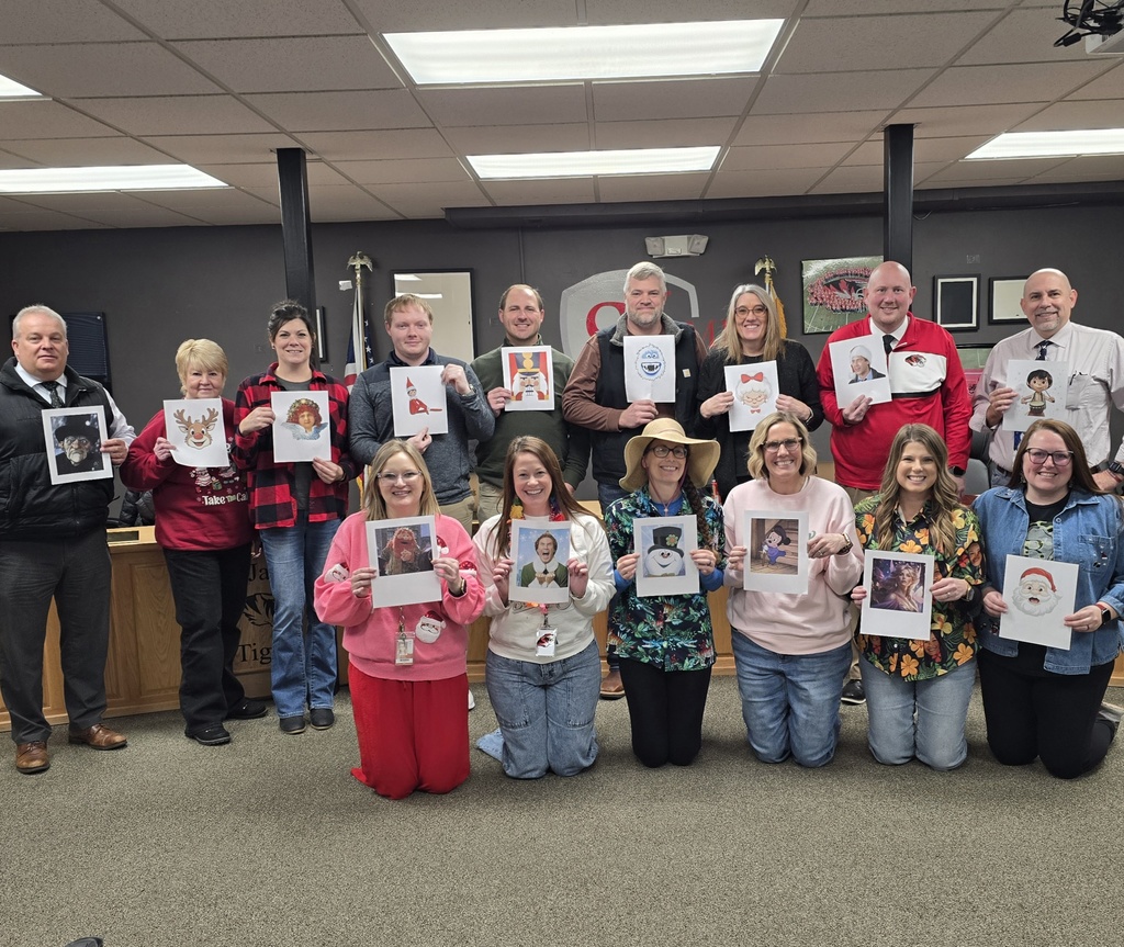 District leaders got into the Christmas spirit during a planning meeting. Pictured are all members holding a photo of a famous character they were voted as resembling.