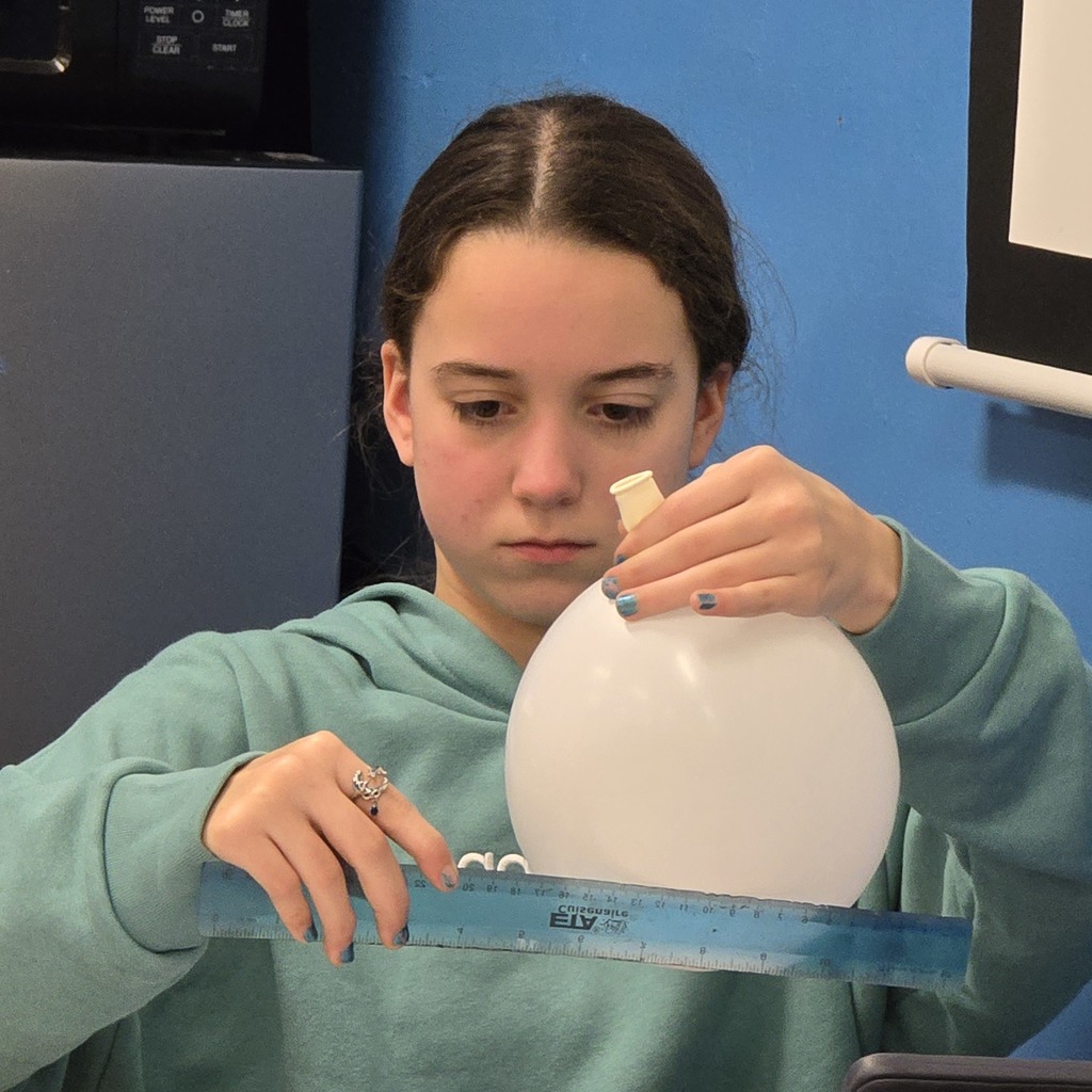 7th grade students learn about lung capacity in science class. 