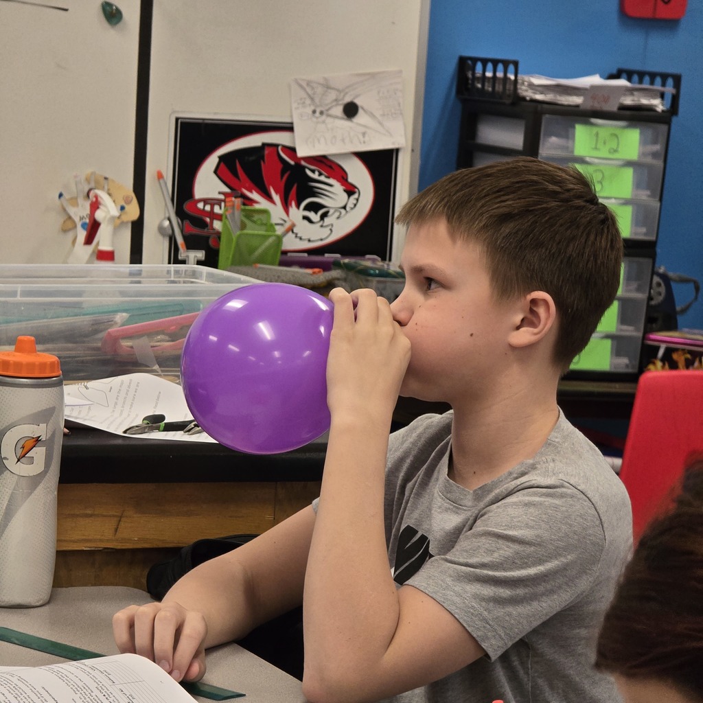 7th grade students learn about lung capacity in science class. 