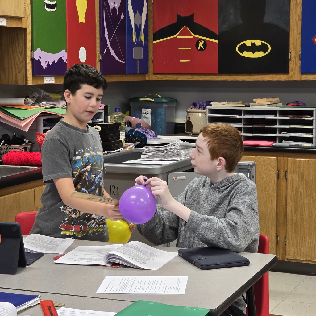 7th grade students learn about lung capacity in science class. 