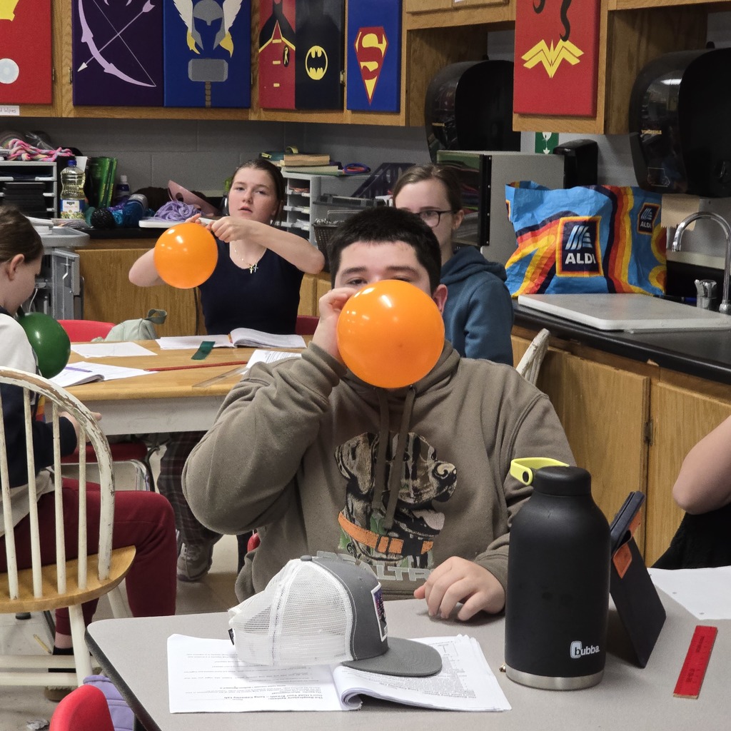 7th grade students learn about lung capacity in science class. 