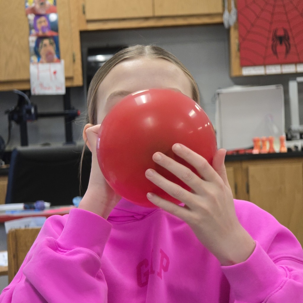 7th grade students learn about lung capacity in science class. 