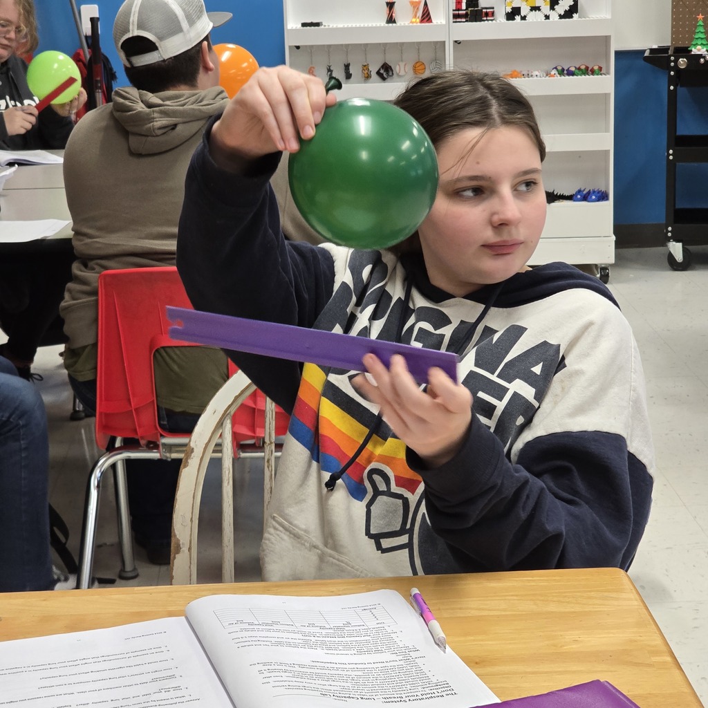 7th grade students learn about lung capacity in science class. 