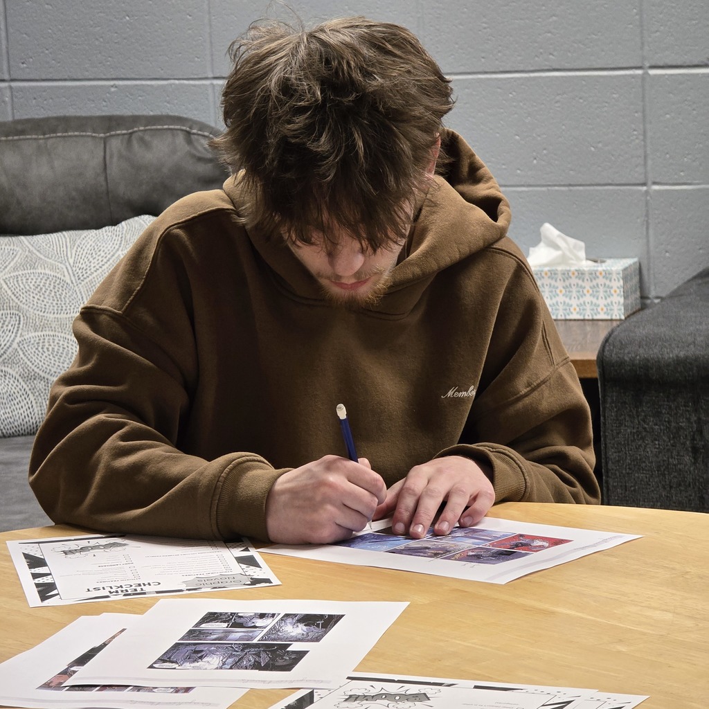 Mythology students learn about graphic novels in the high school library. 