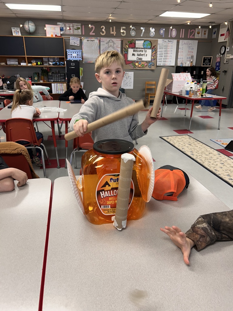 First grade students create instruments with recycled materials. 