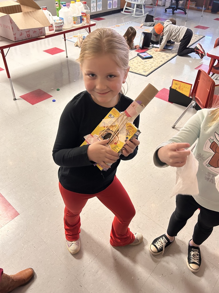 First grade students create instruments with recycled materials. 