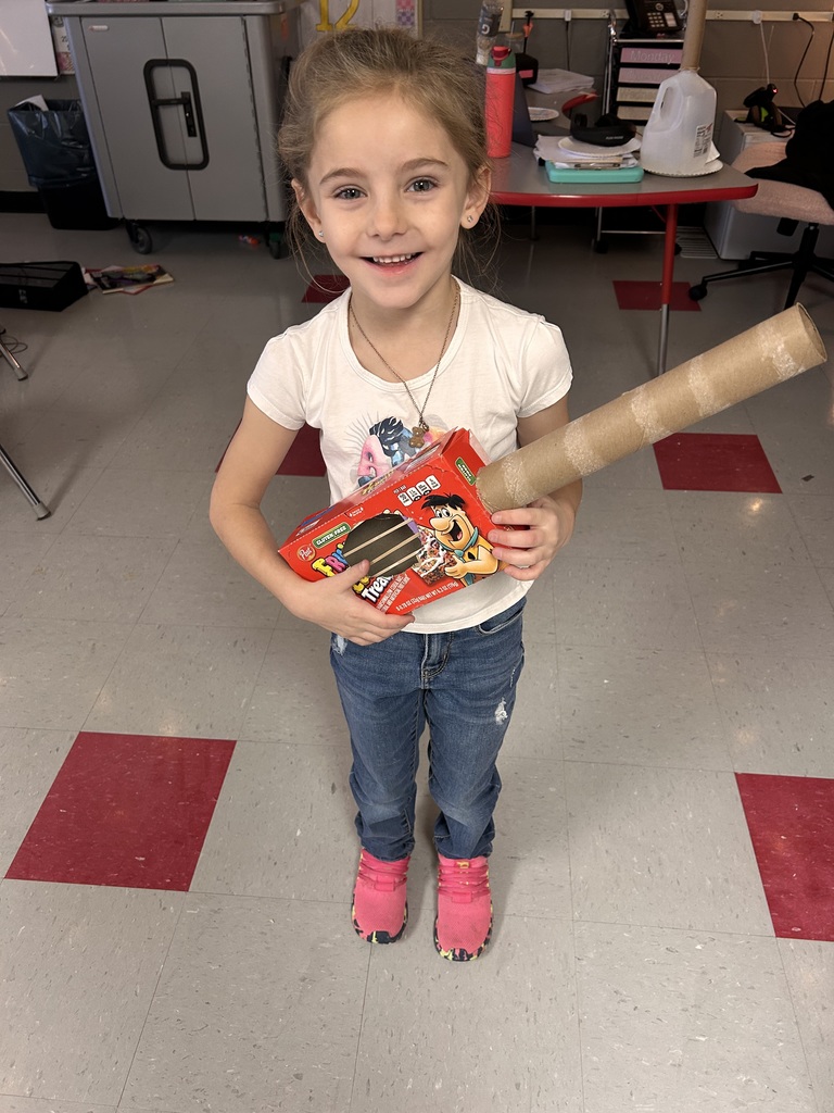 First grade students create instruments with recycled materials. 