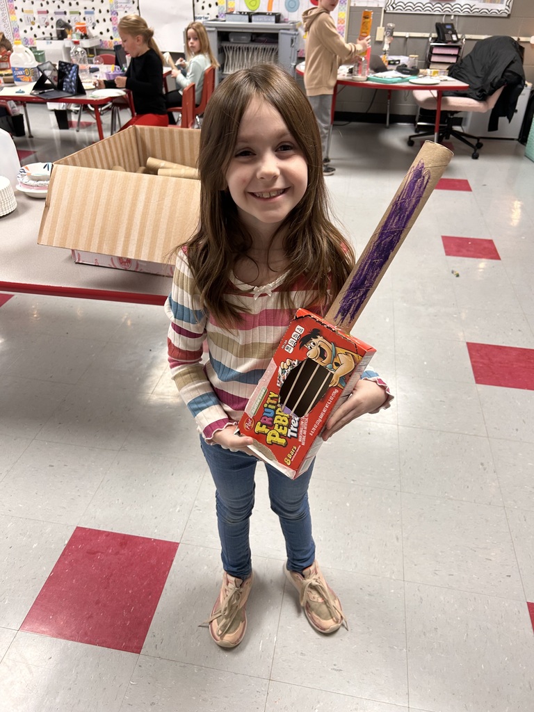First grade students create instruments with recycled materials. 