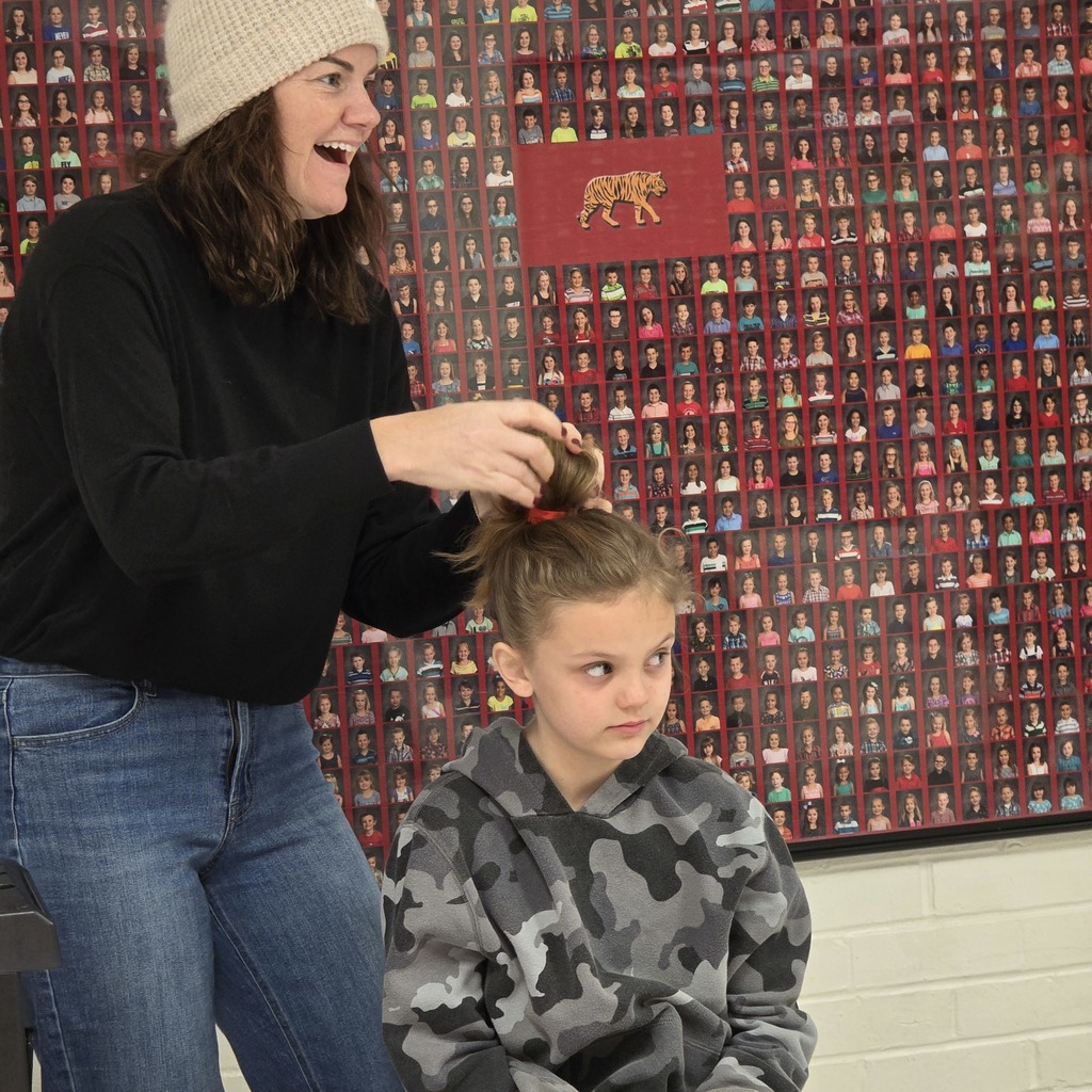 Jumpstart Tigers volunteers fix students hair before school! 