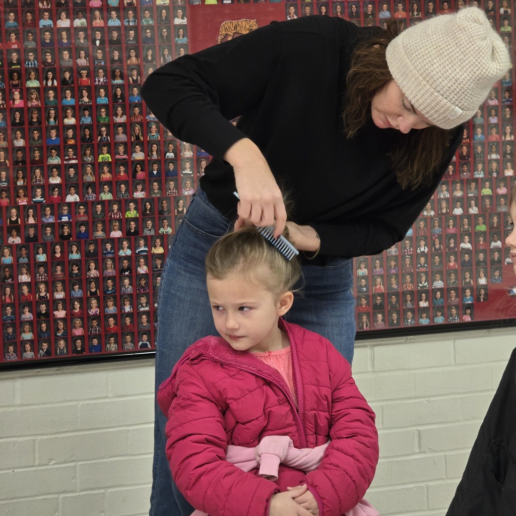 Jumpstart Tigers volunteers fix students hair before school! 