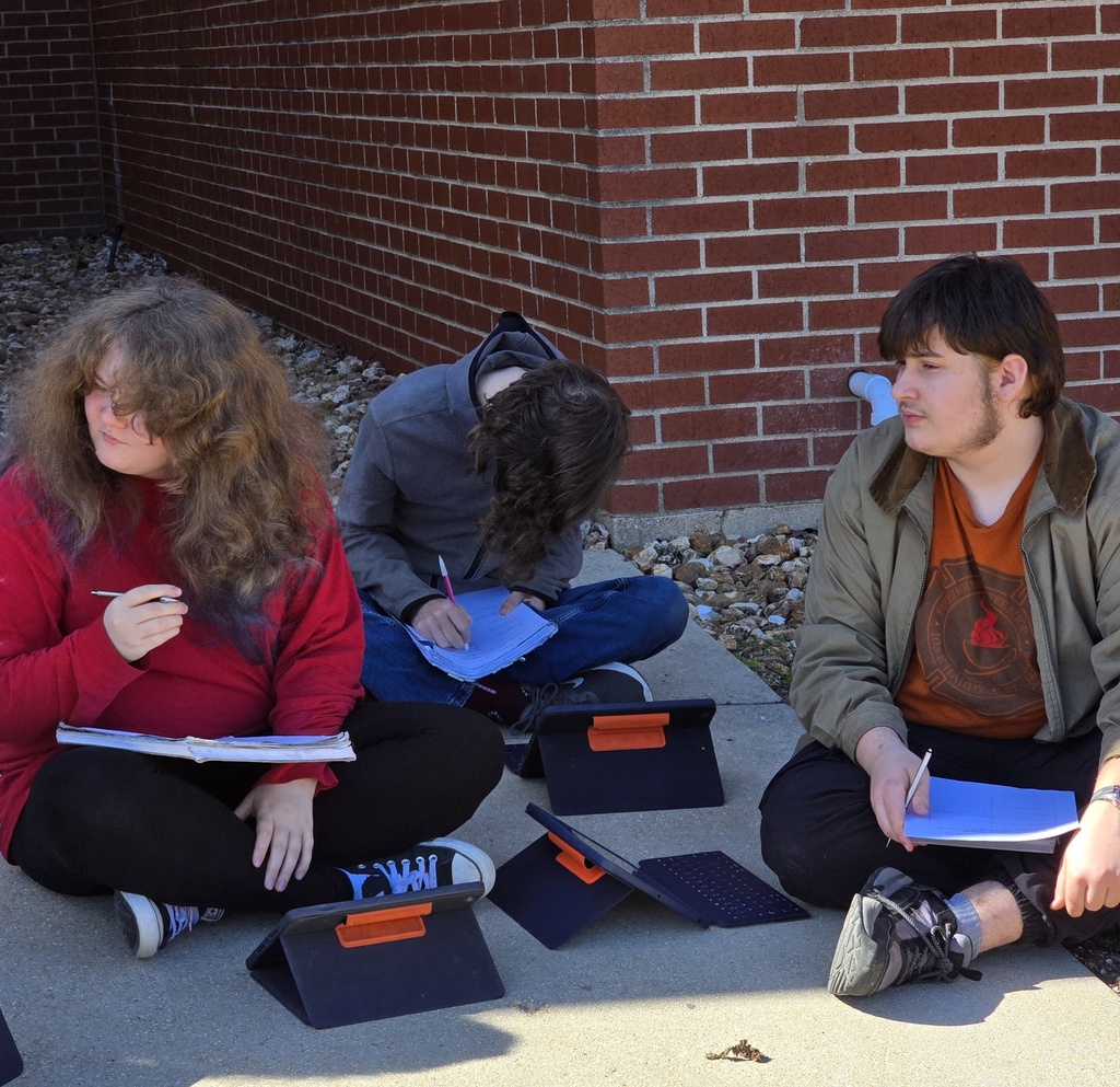 Students enjoy the warm winter weather by studying outside.