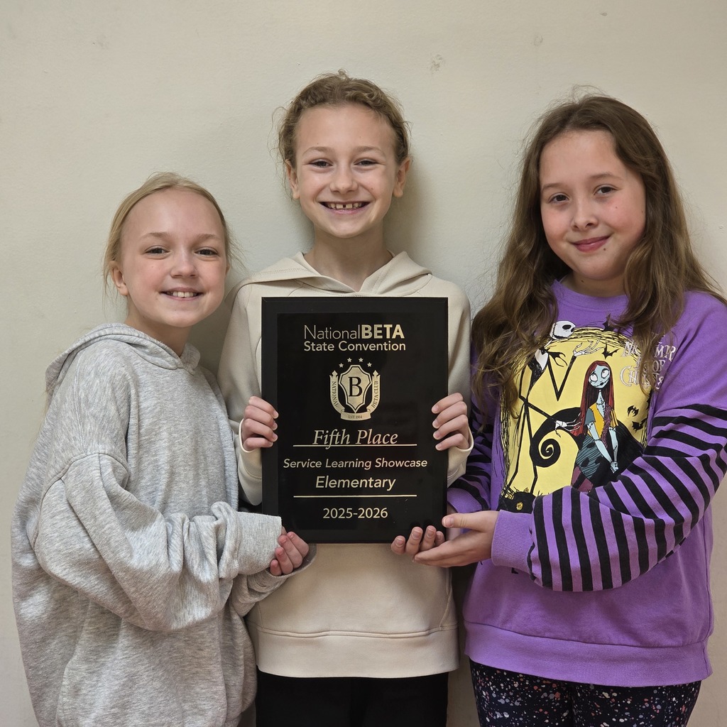 Three girls hold a plaque with "Fifth Place" and "Service Learning Showcase Elementary 2025-2026" written on it.