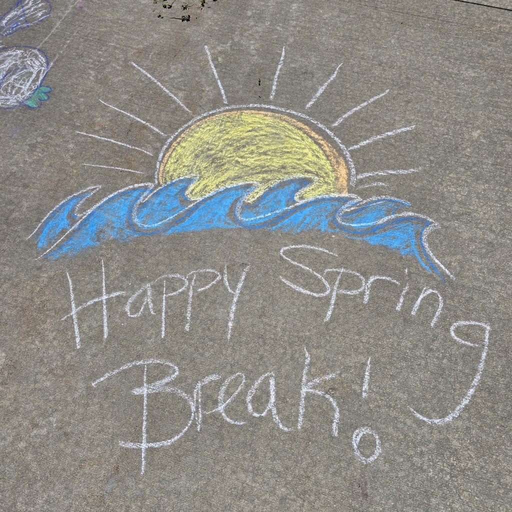 A chalk drawing on the ground with a sun, waves, and the words "Happy Spring Break!"