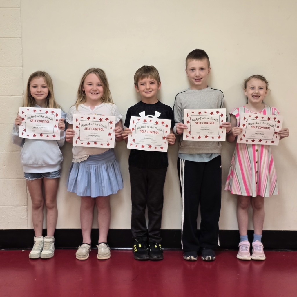 Five children stand together holding certificates, wearing casual clothes. Their shoes and skirts vary in color.