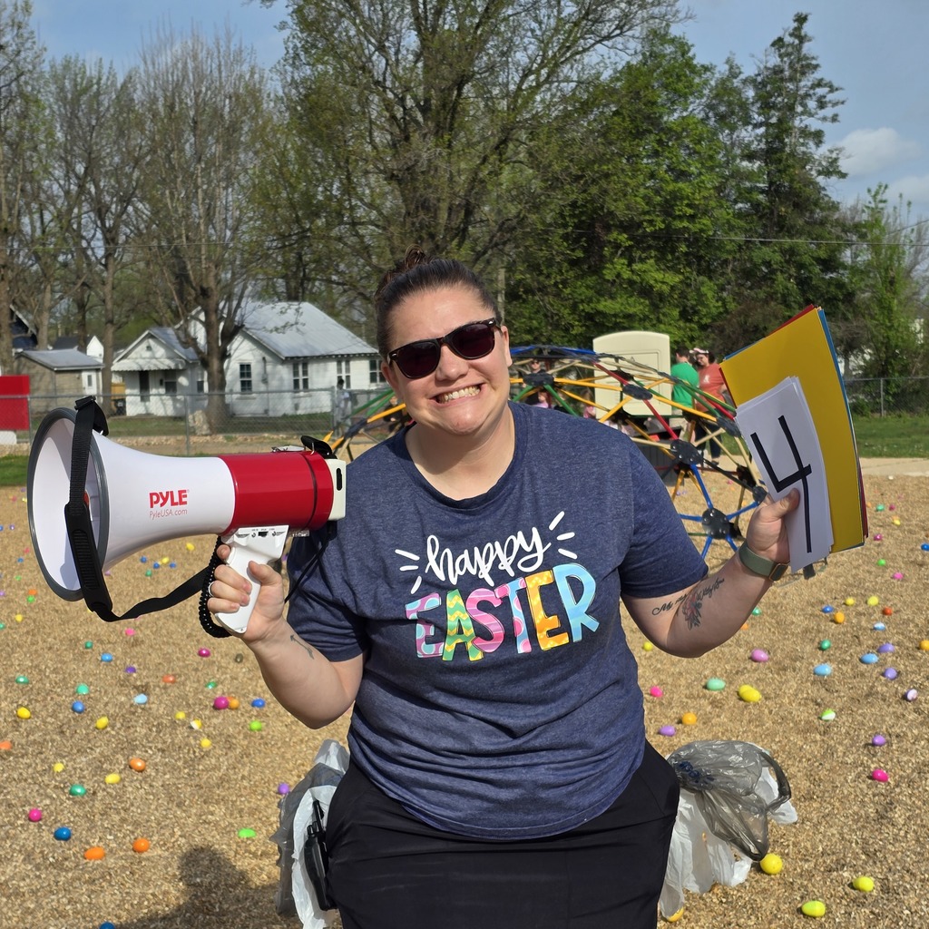 Person in sunglasses and a blue shirt holding a megaphone and card that says Happy Easter.