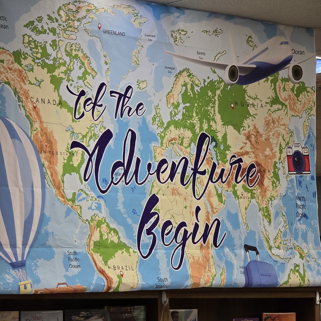 A large map with "Let the Adventure Begin" written on it. A hot air balloon, airplane, and suitcase are featured.