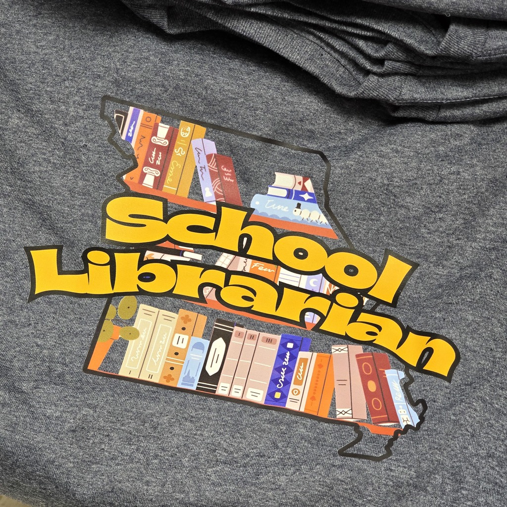 A gray hoodie with a logo depicting books in a shape of a state, labeled "School Librarian."