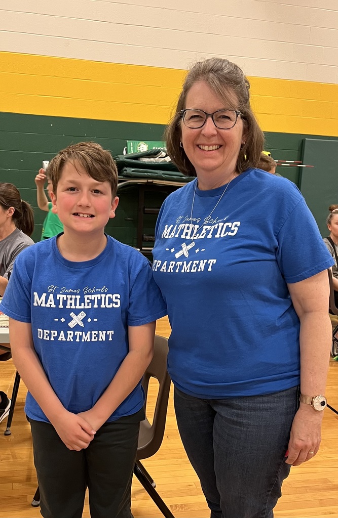Two people in blue shirts with "MATHLETICS DEPARTMENT" text. A woman stands next to a boy in a gymnasium.