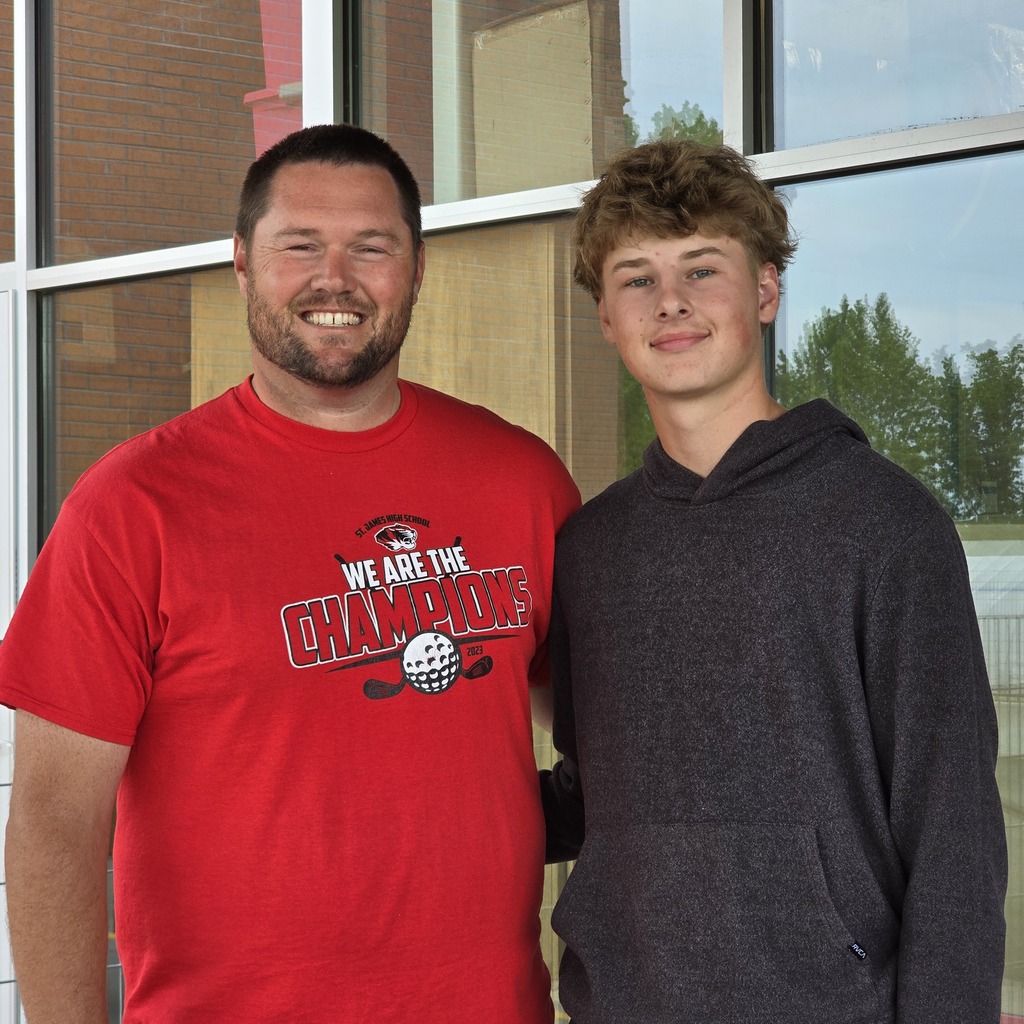 Two men pose for a picture.