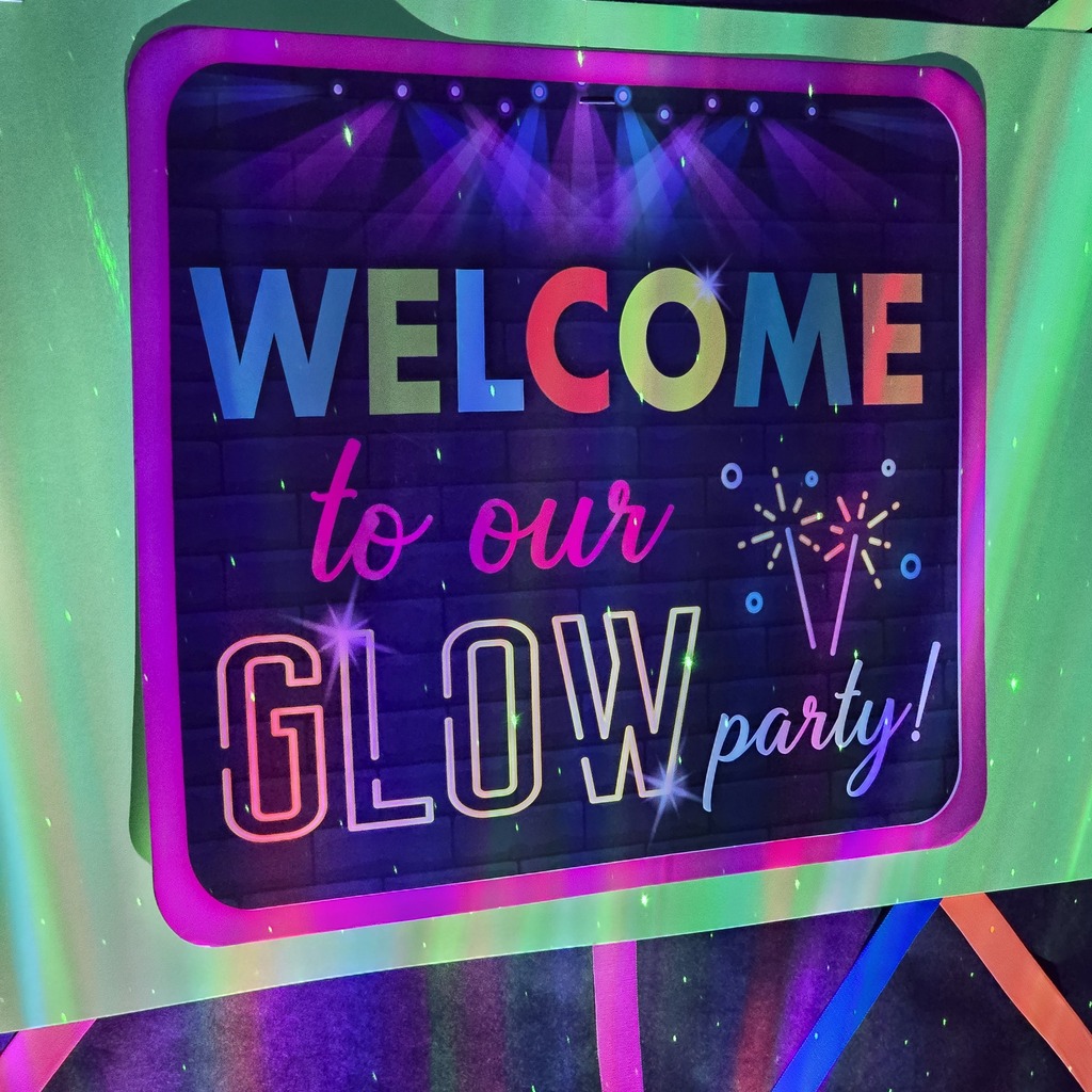 Bright sign with "WELCOME to our GLOW party!" displayed against a colorful background.