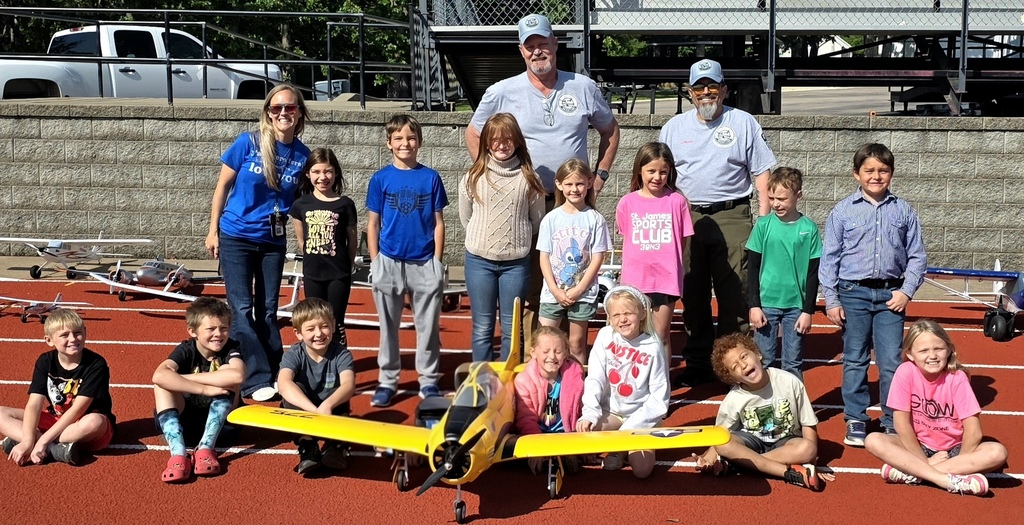 Zoom with second grade. Students pose with RC Plane. 