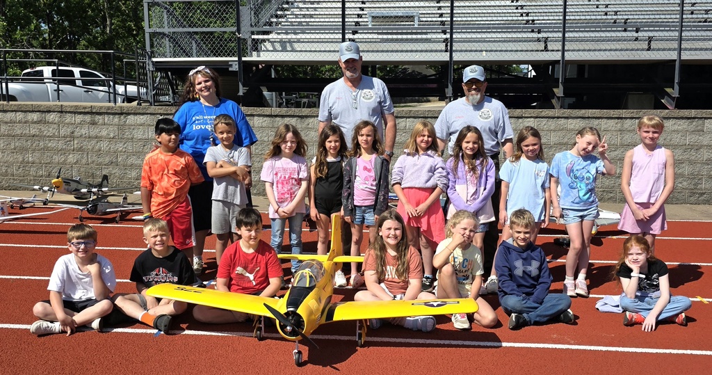 Zoom with second grade. Students pose with RC Plane. 